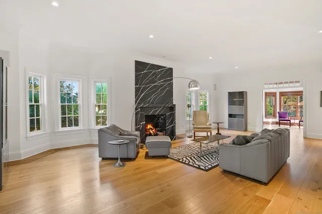 a living room with furniture window and wooden floor