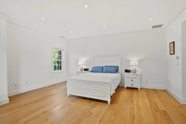 a spacious bedroom with a bed and a table