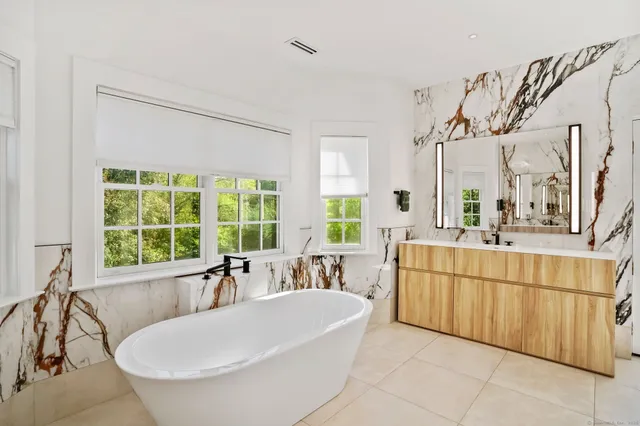 a spacious bathroom with a tub and sink