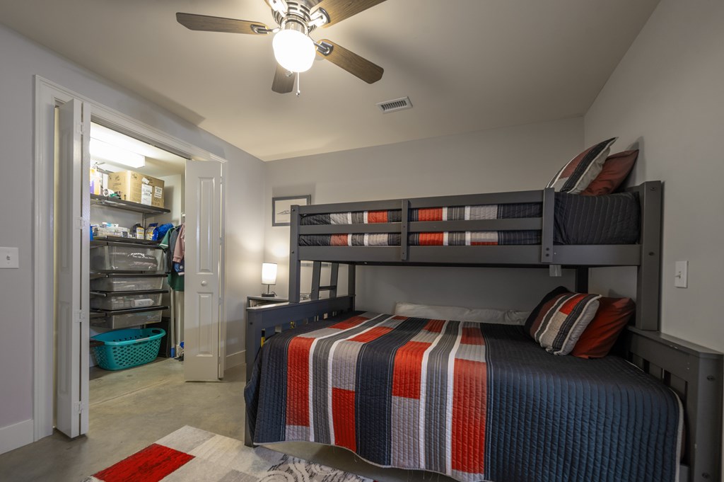 1201 Front Avenue, Unit 509 Columbus, GA 31901 - Photo 11 of 41 a bed room with a bed and a book shelf