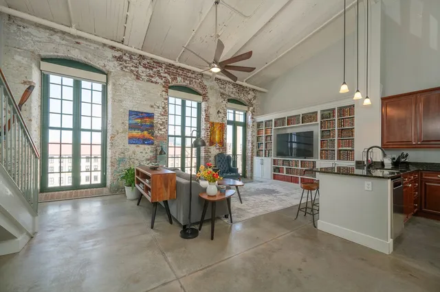 a living room with patio furniture and a flat screen tv