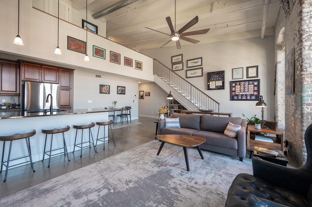 1201 Front Avenue, Unit 509 Columbus, GA 31901 - Photo 18 of 41 a living room with furniture a flat screen tv and a table