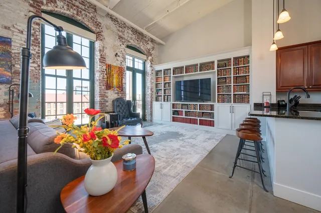 a living room filled with furniture hardwood floor and a table