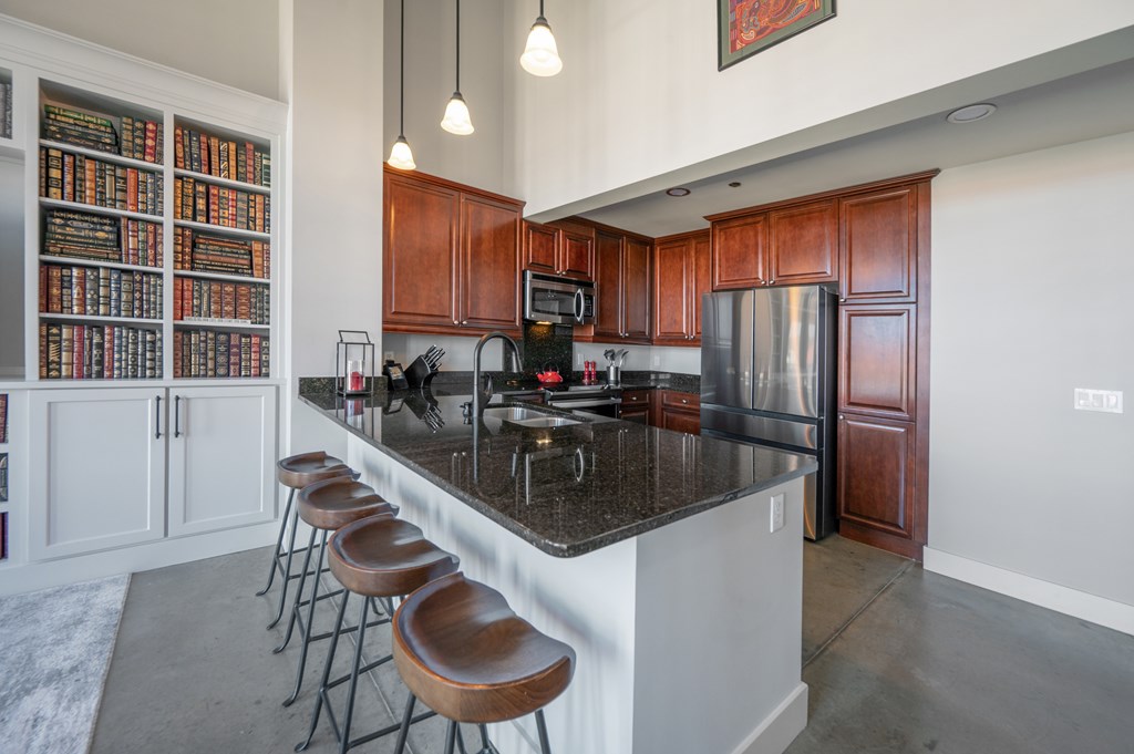1201 Front Avenue, Unit 509 Columbus, GA 31901 - Photo 22 of 41 a kitchen with kitchen island a counter top space cabinets and stainless steel appliances