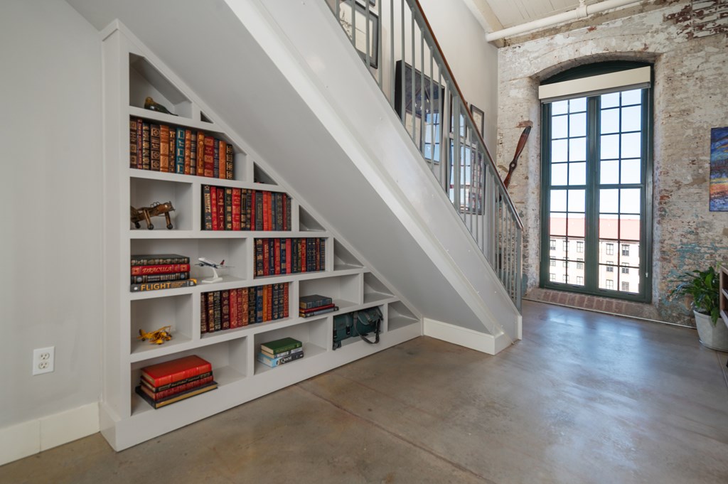 1201 Front Avenue, Unit 509 Columbus, GA 31901 - Photo 25 of 41 a room with lots of white walls and a book shelf