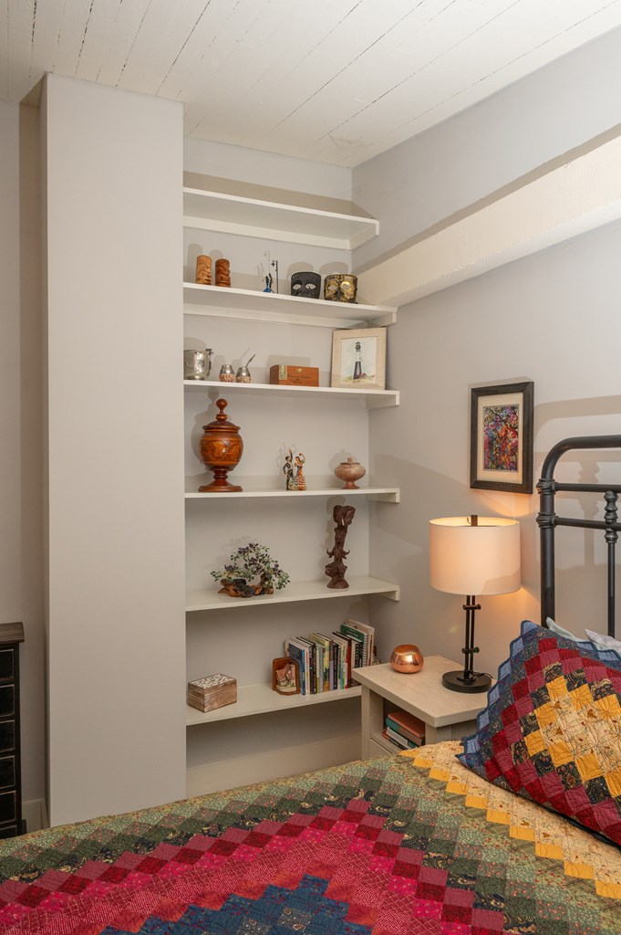 1201 Front Avenue, Unit 509 Columbus, GA 31901 - Photo 32 of 41 a bedroom with furniture and a book shelf