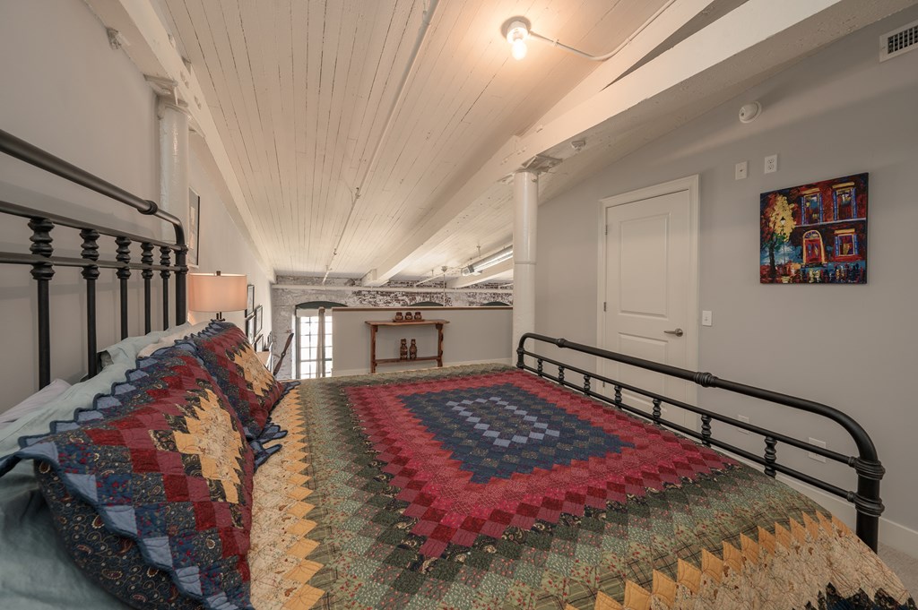 1201 Front Avenue, Unit 509 Columbus, GA 31901 - Photo 36 of 41 a bed sitting in a bedroom next to a window