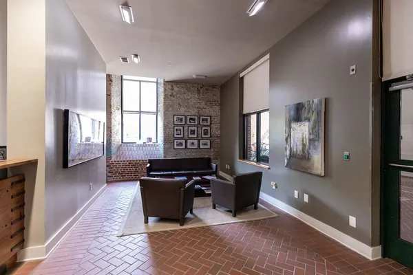 a kitchen with stainless steel appliances kitchen island granite countertop a refrigerator and a sink