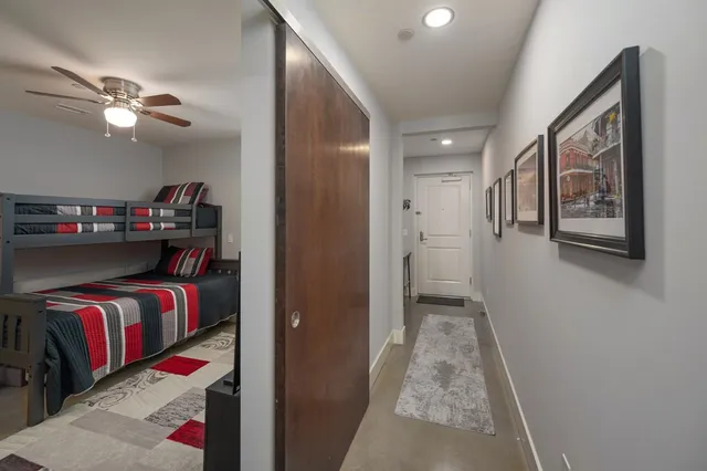 a view of a hallway and a livingroom with furniture