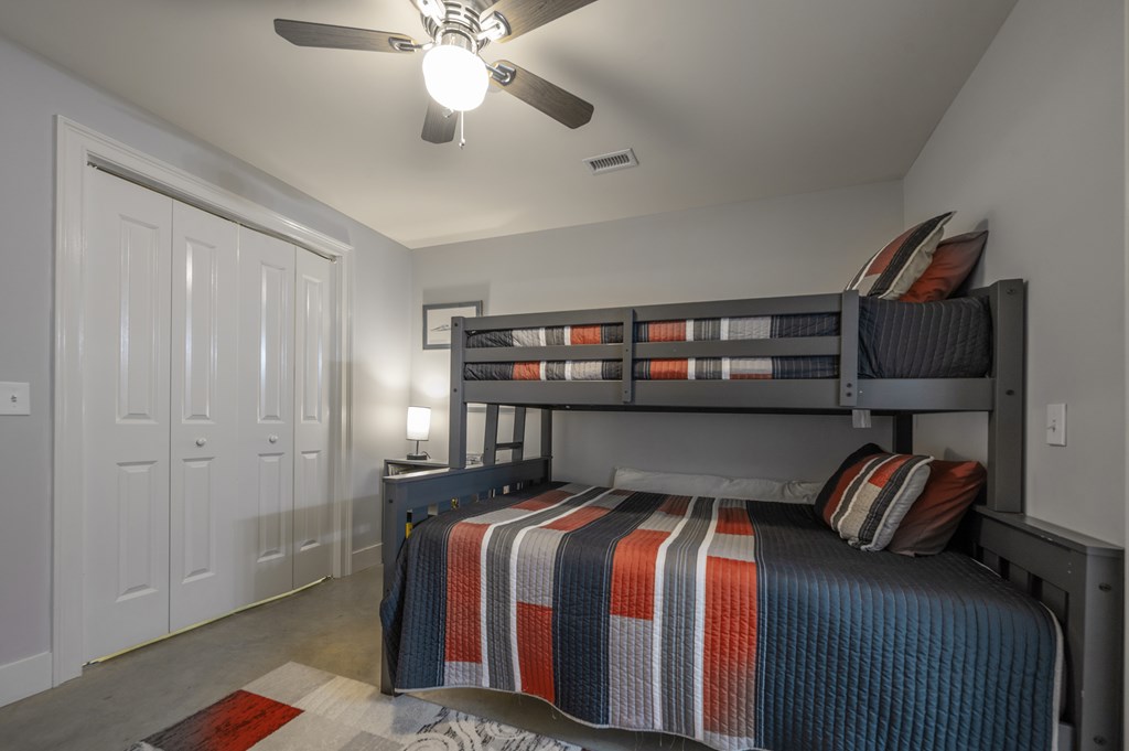 1201 Front Avenue, Unit 509 Columbus, GA 31901 - Photo 10 of 41 a bed sitting in a bedroom next to a cabinet