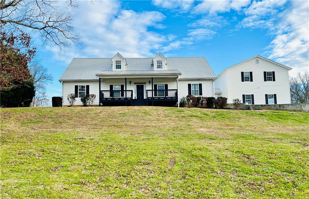 a front view of a house with a large pool