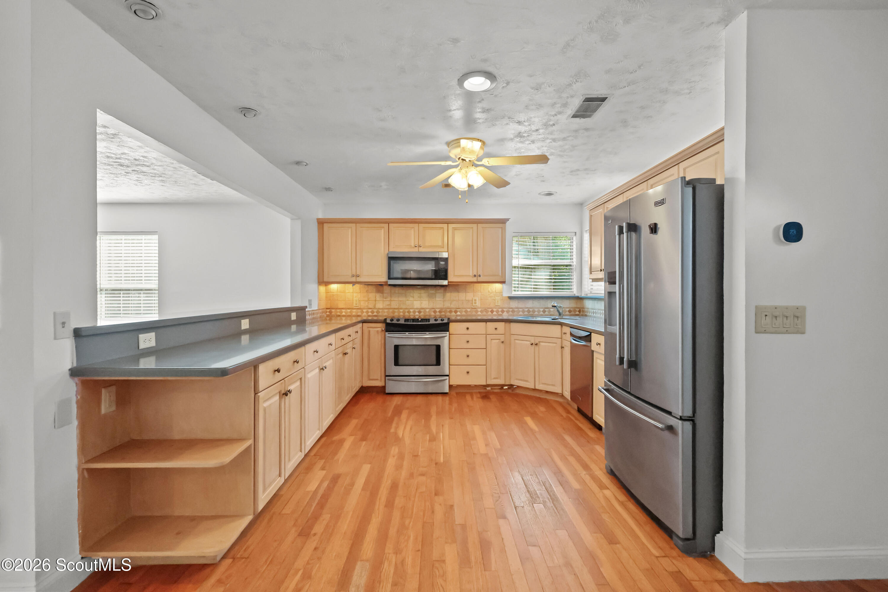 104 Sapelo Street St. Simons Island, GA 31522 - Photo 19 of 45 Kitchen leads to large back deck