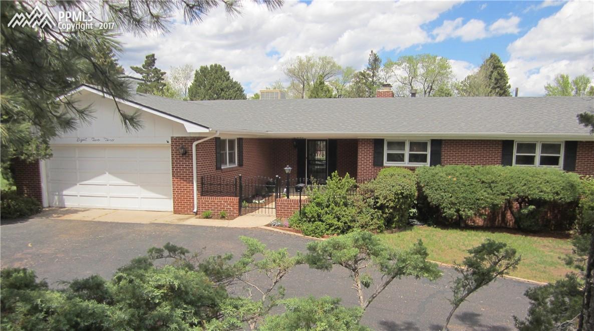 823 Cresta Road Colorado Springs, CO 80905 - Photo 1 of 36 Ranch style home with red brick exterior, enclosed courtyard and semi-circular driveway. Features extra parking space.