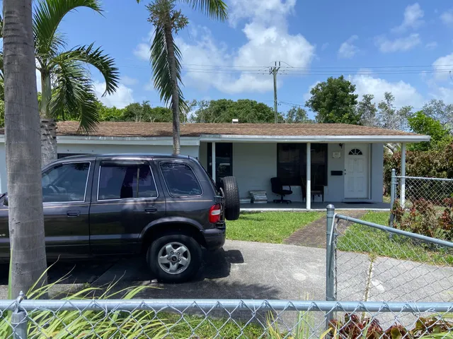 a view of a car parked in front of a house