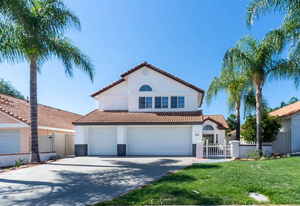 24339 Gitano Drive Murrieta, CA 92562 - Photo 1 of 1 a front view of a house with a yard and palm trees