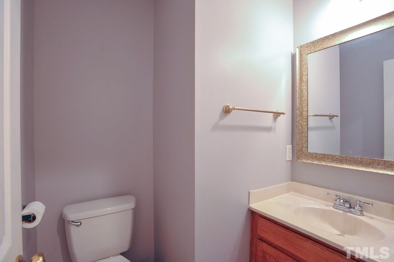 4604 Old Poole Road Raleigh, NC 27610 - Photo 14 of 14 a bathroom with a granite countertop toilet and a sink