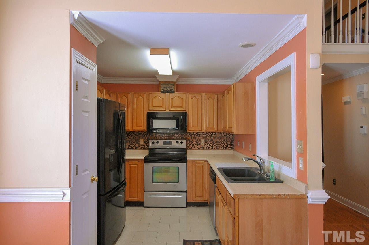 4604 Old Poole Road Raleigh, NC 27610 - Photo 5 of 14 a kitchen with a stove and a refrigerator