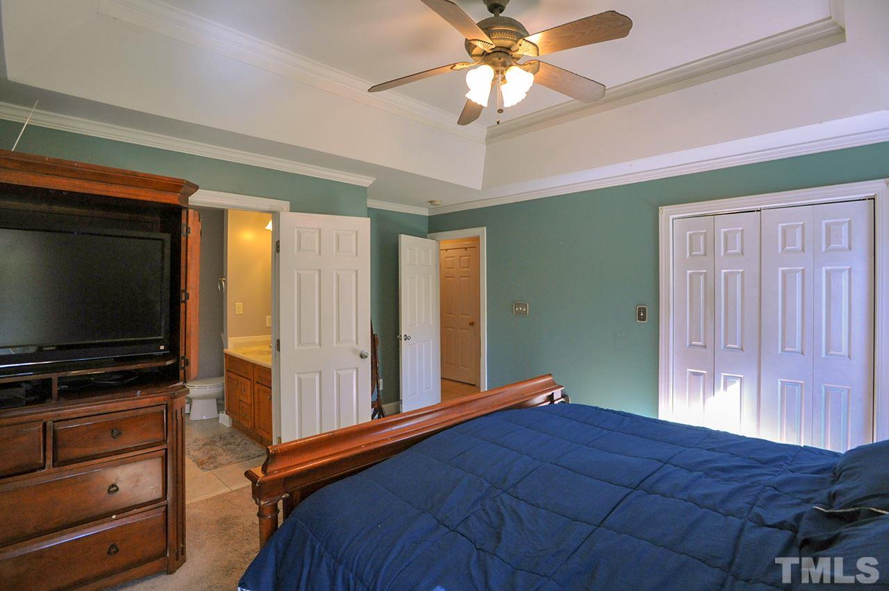 4604 Old Poole Road Raleigh, NC 27610 - Photo 7 of 14 a bedroom with a bed and a flat screen tv