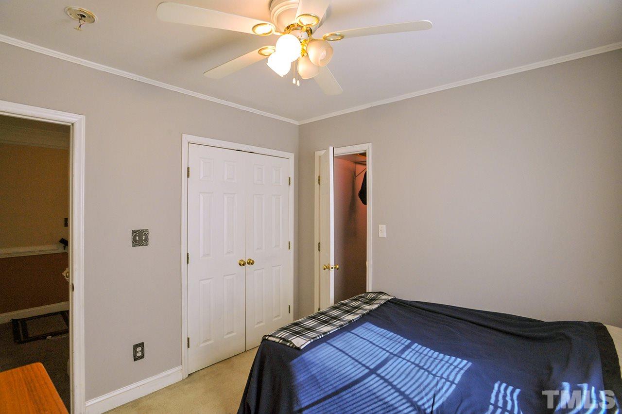 4604 Old Poole Road Raleigh, NC 27610 - Photo 9 of 14 a bedroom with a bed and a chandelier fan