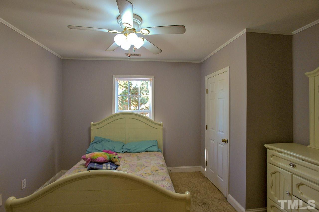 4604 Old Poole Road Raleigh, NC 27610 - Photo 10 of 14 a bedroom with a bed and a window