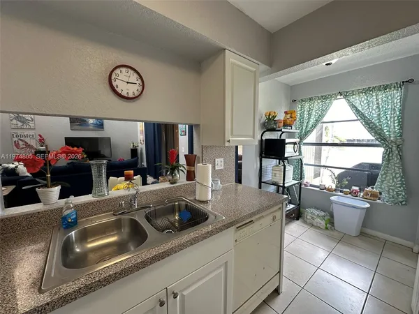 a kitchen with a sink and a refrigerator