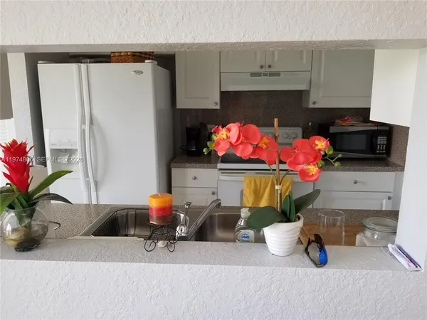 a bathroom with a sink a potted plant and a potted plant