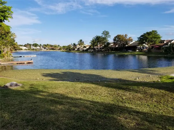 a view of a lake with houses in the back