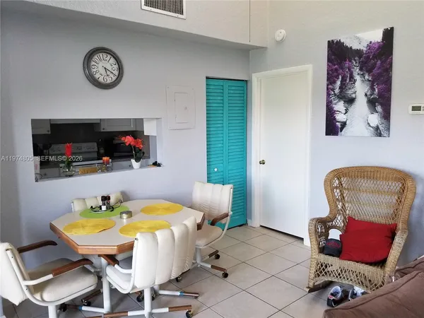 a dining room with furniture and a flat screen tv