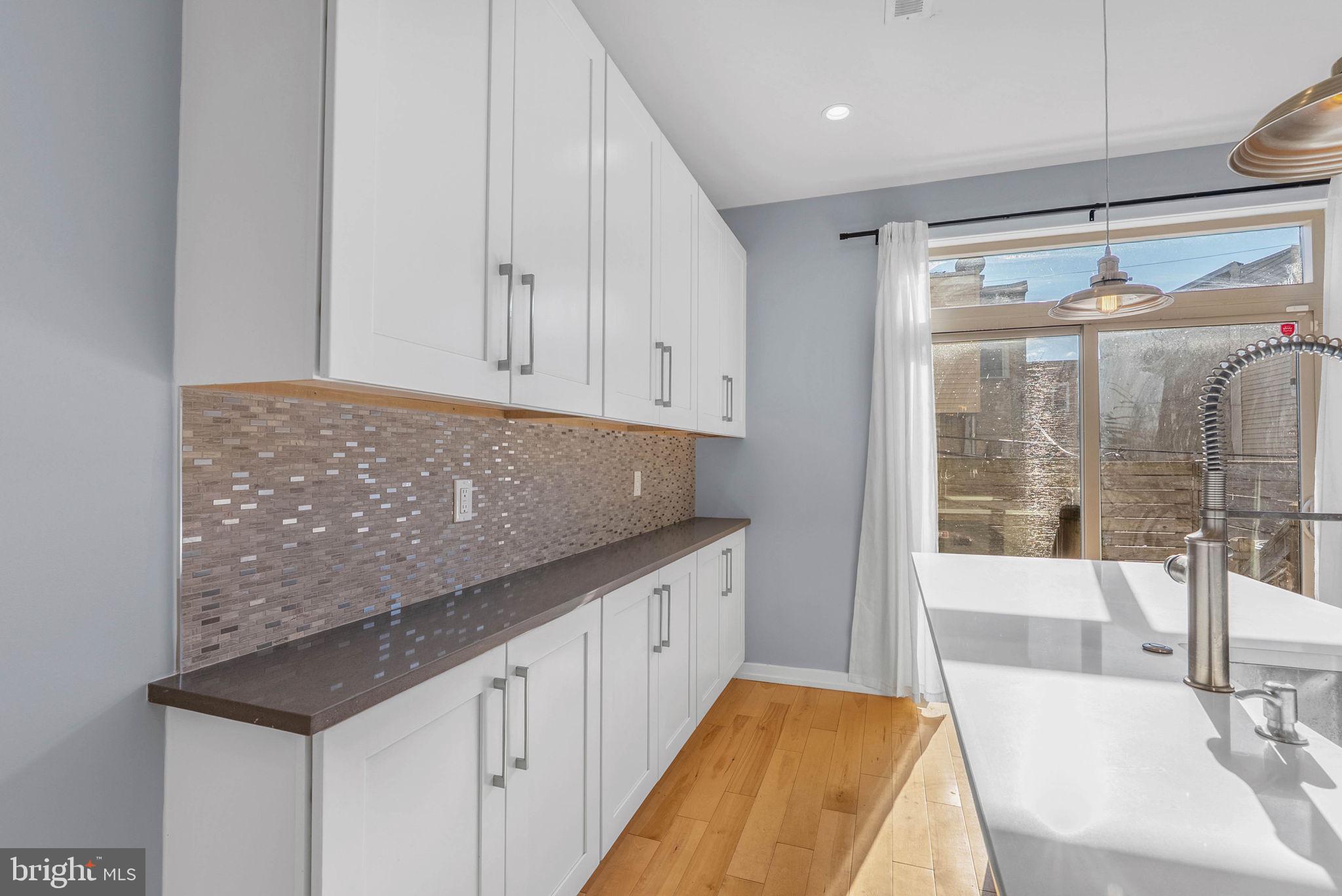 1912 Gerritt Street Philadelphia, PA 19146 - Photo 12 of 40 a spacious bathroom with a granite countertop sink and a large mirror