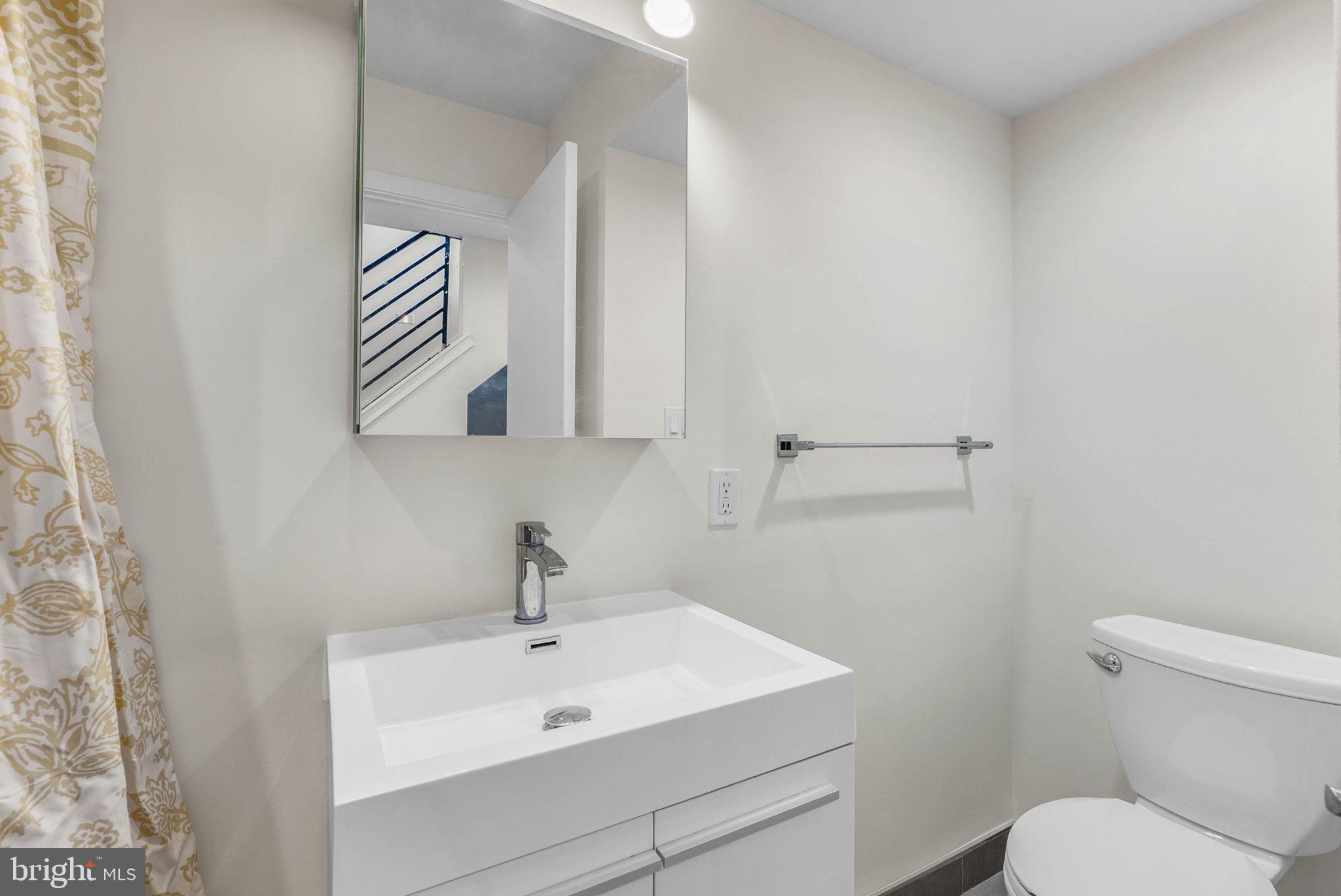 1912 Gerritt Street Philadelphia, PA 19146 - Photo 20 of 40 a bathroom with a toilet a sink and mirror