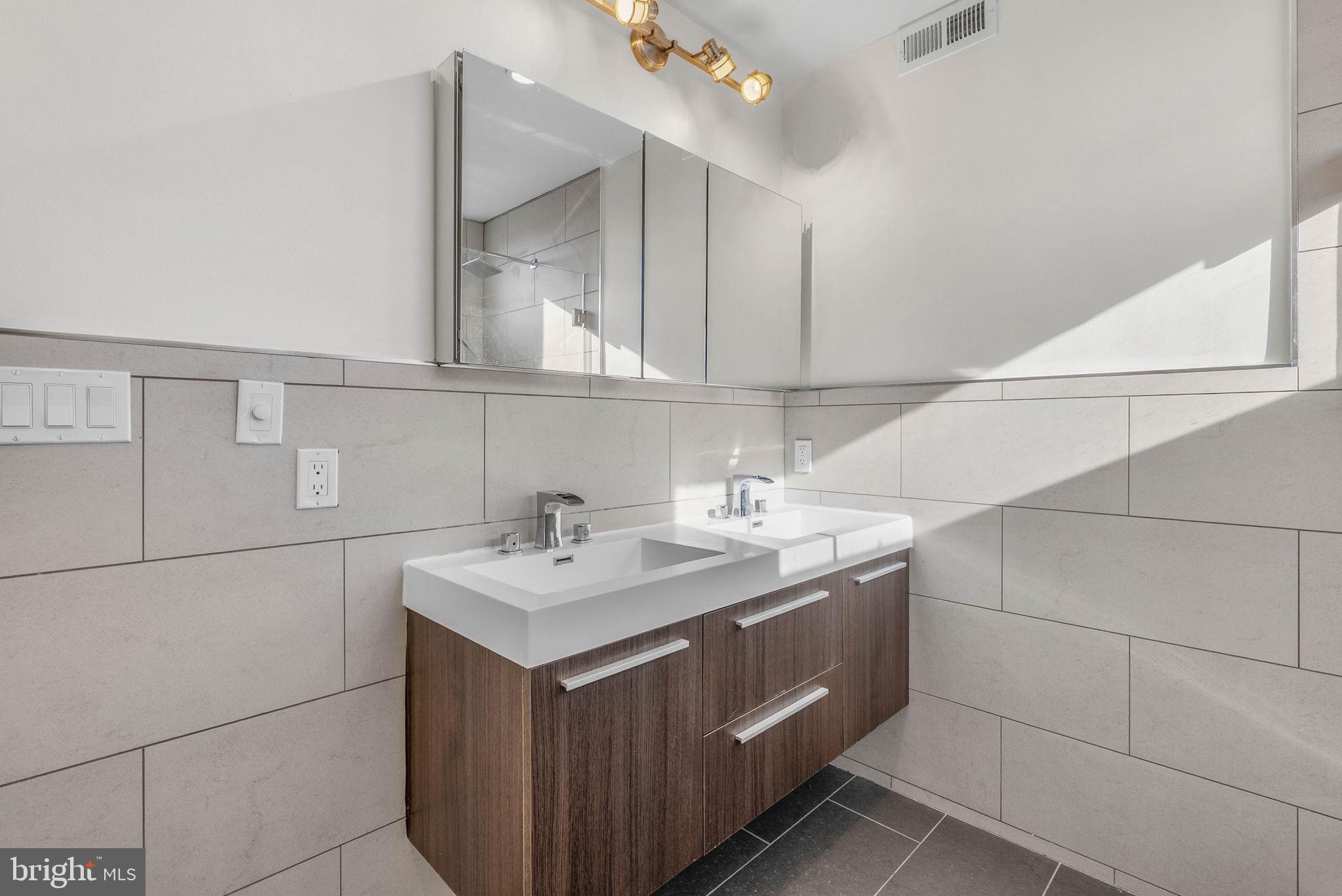1912 Gerritt Street Philadelphia, PA 19146 - Photo 28 of 40 a bathroom with a sink vanity and mirror