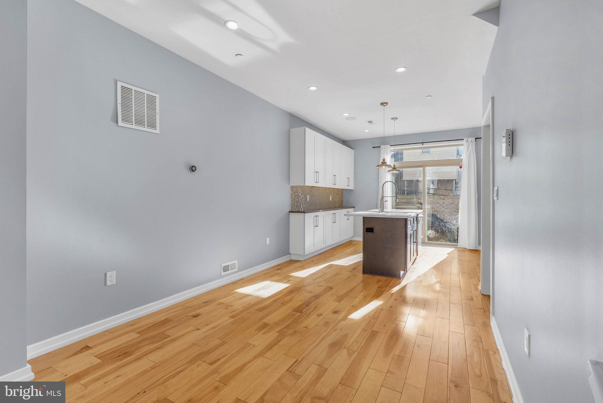 1912 Gerritt Street Philadelphia, PA 19146 - Photo 8 of 40 a kitchen with stainless steel appliances kitchen island a large counter top and a wooden floors