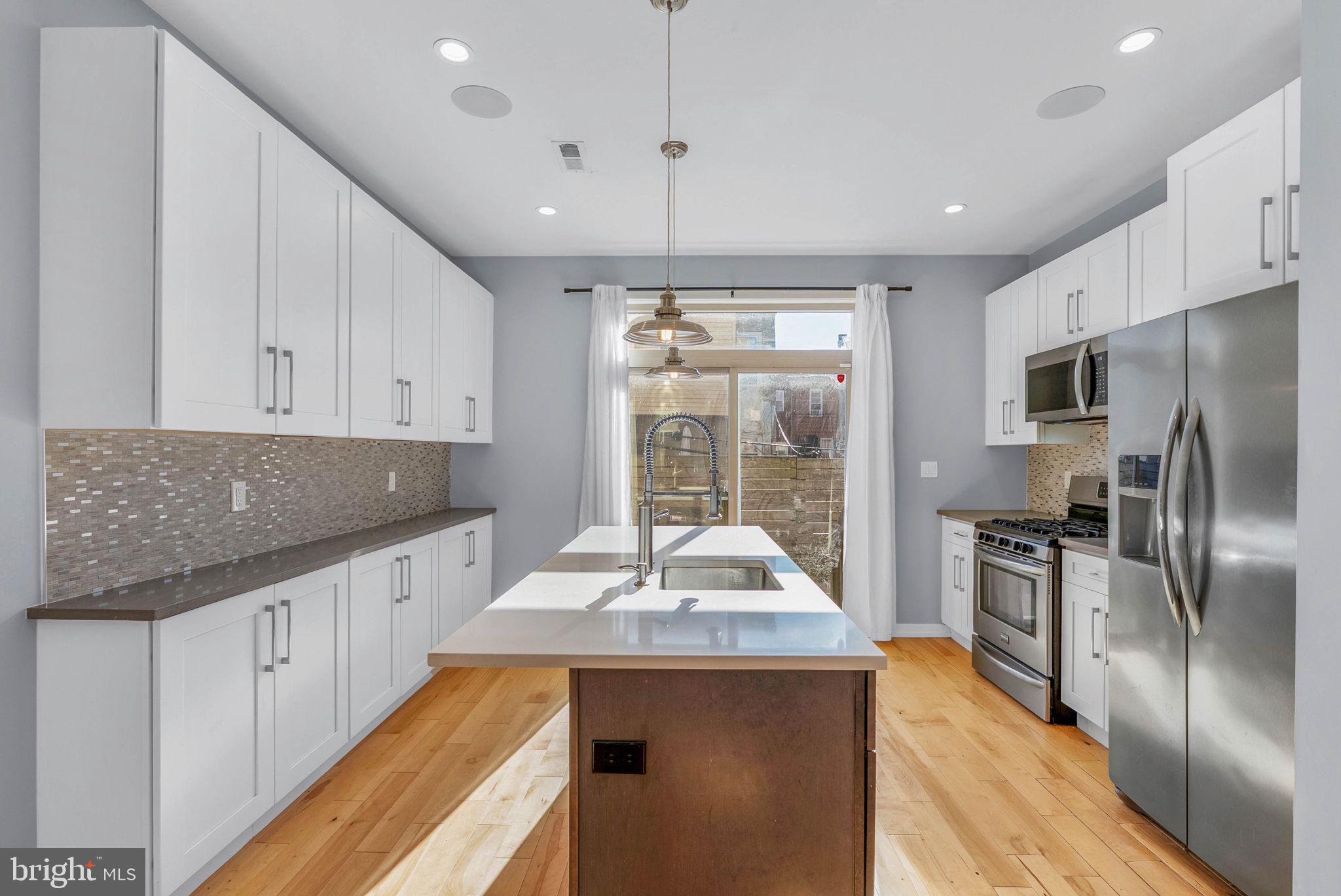 1912 Gerritt Street Philadelphia, PA 19146 - Photo 10 of 40 a kitchen with stainless steel appliances kitchen island granite countertop a sink and refrigerator