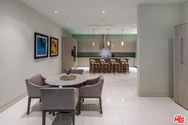 a view of a patio with table and chairs potted plants and large tree