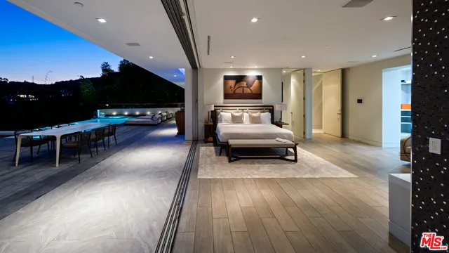 a view of a patio with couches table and chairs and potted plants
