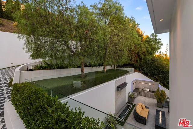 a view of a sink and yard from a balcony