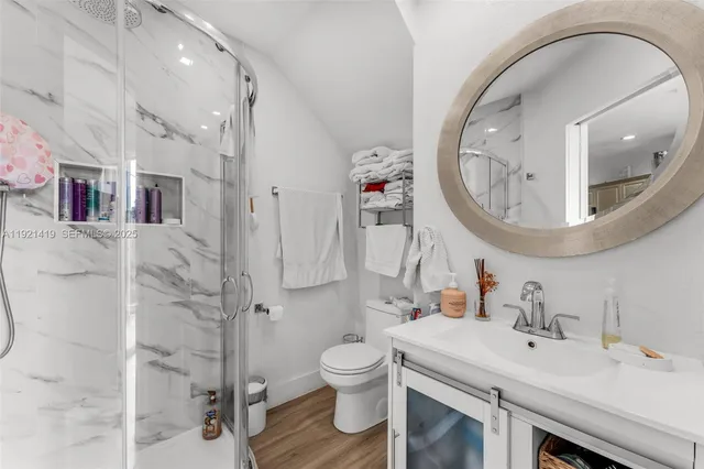 a bathroom with a sink a toilet and a mirror