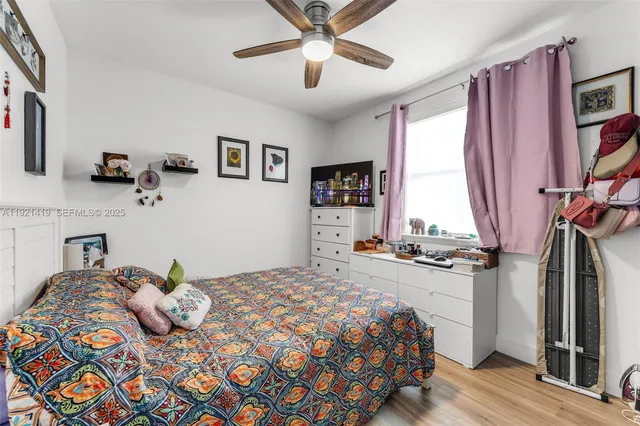 a bedroom with a bed dresser and a window