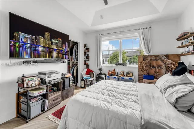 a bedroom with bed and a window