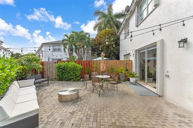 a view of a patio with table and chairs and potted plants