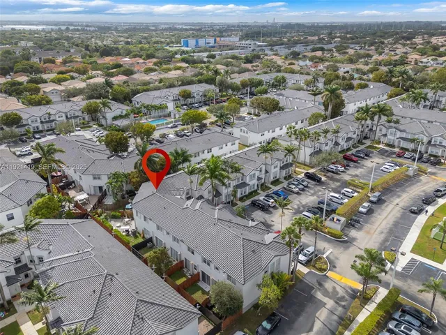 an aerial view of residential houses with outdoor space