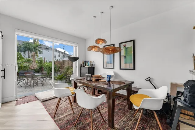 a dining room with furniture and wooden floor