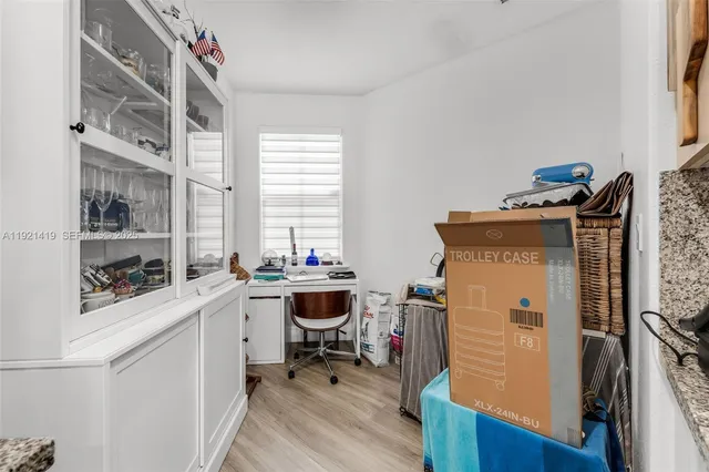 a view of a workspace with furniture and a window