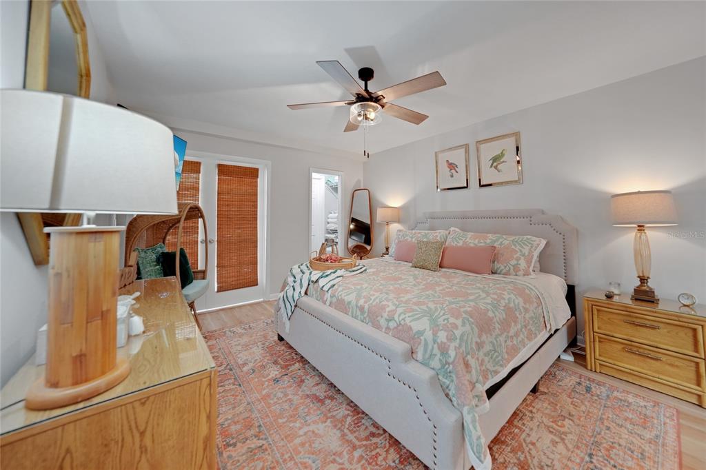 1591 Beach Road, Unit 202 Englewood, FL 34223 - Photo 13 of 46 a spacious bedroom with a bed and wooden floor