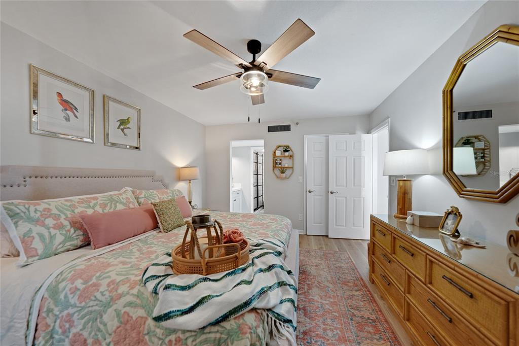 1591 Beach Road, Unit 202 Englewood, FL 34223 - Photo 15 of 46 a bed room with a bed and a chandelier