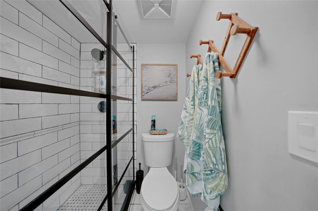 1591 Beach Road, Unit 202 Englewood, FL 34223 - Photo 18 of 46 a bathroom with a toilet and a shower