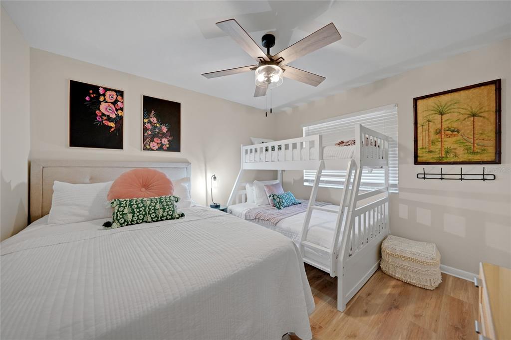 1591 Beach Road, Unit 202 Englewood, FL 34223 - Photo 19 of 46 a bedroom with a bed and a painting on the wall