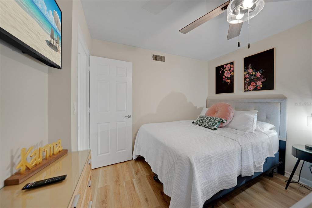 1591 Beach Road, Unit 202 Englewood, FL 34223 - Photo 20 of 46 a bedroom with a bed and a painting on the wall