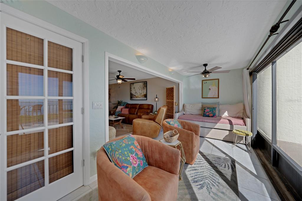 1591 Beach Road, Unit 202 Englewood, FL 34223 - Photo 23 of 46 a living room with furniture a flat screen tv and a window