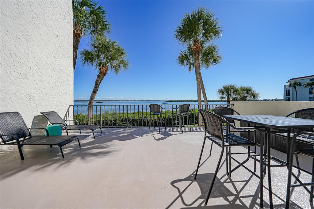 1591 Beach Road, Unit 202 Englewood, FL 34223 - Photo 28 of 46 a view of a swimming pool with a table and chairs